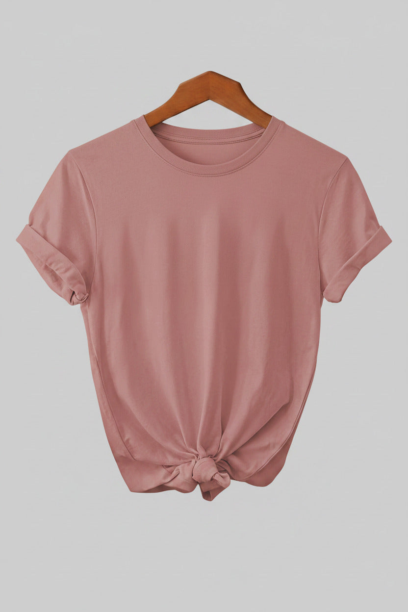 Pink t-shirt on a hanger with jeans in the background