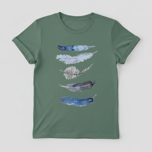 Green t-shirt with feather design on a hanger against a denim background